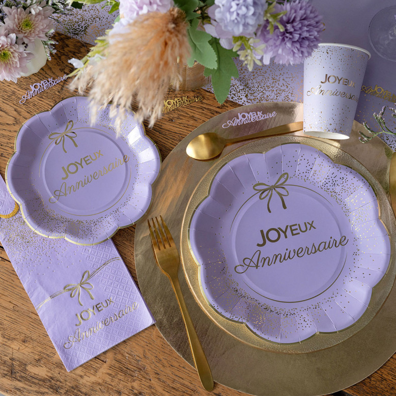 Assiette Joyeux Anniversaire lilas et or 18 cm en carton avec bord festonné, nœud et confettis dorés Assiette Joyeux Anniversaire lilas et or 18 cm en carton avec bord festonné, nœud et confettis dorés